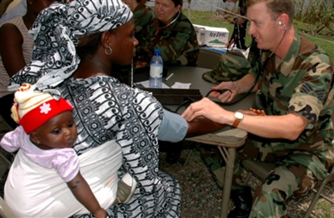 U.S. Air Force Staff Sgt. Stephen Young takes the blood pressure of a patient during MEDFLAG 2006 at the Nima Governmental Clinic in Accra, Ghana Sept. 11, 2006. Medical personnel from U.S. Air Forces in Europe are treating residents and training local health care workers during this medical-training exercise.