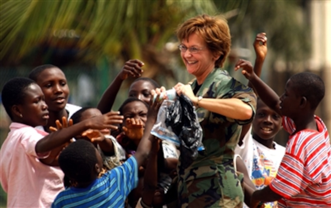 U.S. Air Force Senior Master Sgt. Holly Durkop, the First Sgt. of the 119th Medical Group, hands out toys to chidren during MEDFLAG 2006 at the Osu Orphanage in Accra, Ghana, Sept. 7, 2006. Medical personnel from U.S. Air Forces in Europe are treating residents and training local health care workers during this medical-training exercise.
