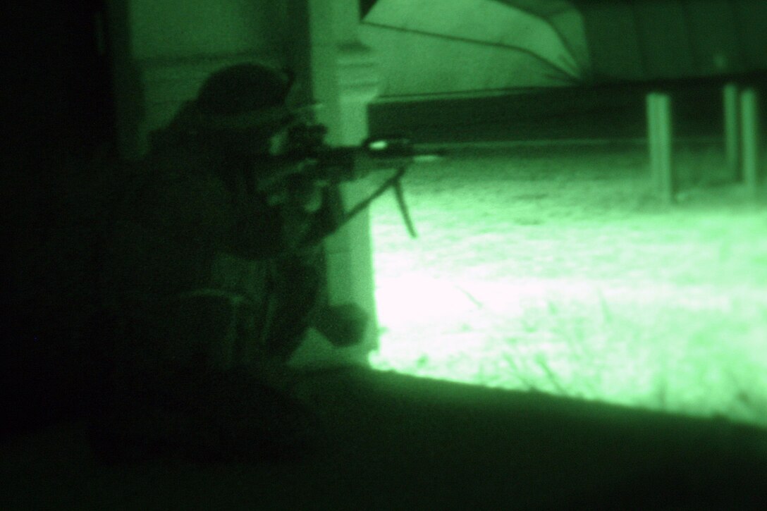 KAUAI, Hawaii (Sept. 20, 2006) -- Marines with Echo Co., Battalion Landing Team 2/4, 15th Marine Expeditionary Unit (Special Operations Capable), takes cover and provides security during a helicopter raid. The 15th MEU (SOC) is training to sharpen their war fighting capabilities, and improve their skills as a Marine Air Ground Task Force, as they continue their deployment.