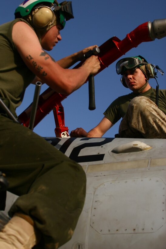 Lance Cpl. Phillip Slaughter (left) and Sgt. Kevin Hudson prepare the fueling probe of one of the F/A-18C Hornets at Al Asad, Iraq, Sept. 21. Slaughter is an F/A-18 fixed-wing aircraft airframe mechanic with Marine Fighter Attack Squadron 251, Carrier Air Wing One, Carrier Strike Group Twelve. Slaughter is a native of Brookpark, Ohio. Hudson is an F/A-18 fixed-wing aircraft airframe mechanic with VMFA-251. Hudson is a Talladega, Ala., native.