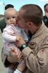 Lydia Welch, 8 months, gets a kiss from daddy, Capt. Stew Welch, 9th Air refueling Squadron Travis Air Force Base, Calif., after he came back from deployment in support of the Global War on Terrorism. (U.S. Air Force photo/Staff Sgt. Matt McGovern/60th AMW Public Affairs)