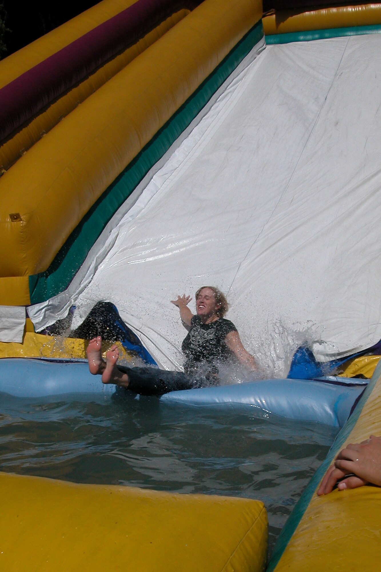 Staff Sgt. Julie Miles, 56th Aerial Port Squadron, cools off with the help of an inflatable water slide during the annual base wide picnic held on Saturday, September 16.  The local communities of Riverside and Moreno Valley organized and funded the picnic to show their appreciation to the military members who work at the base.  More than 5,000 military members and their families attended the event.  This is the 34th appreciate day picnic the community has hosted for March Air Reserve Base.  (U.S. Air Force photo by Staff Sgt. Amy Abbott)