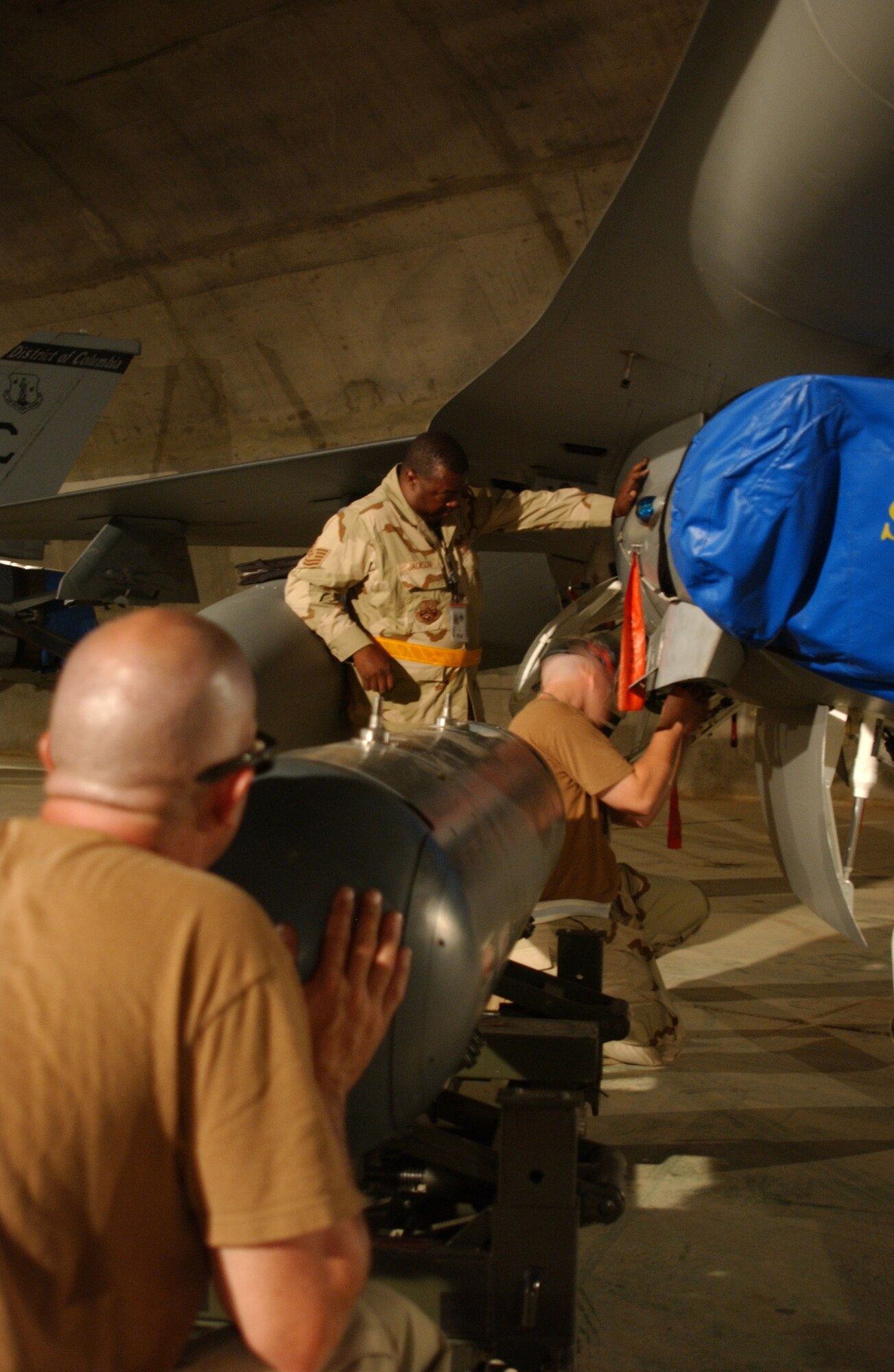 Maintainers from the 332nd Expeditionary Aircraft Maintenance Squadron prepare an F-16 Fighting Falcon for a reconnaissance pod at Balad Air Base, Iraq, Sept. 20. Maintainers brought newly arrived Guard F-16s online. The jet is one of many Guard jets from South Dakota, Michigan, New York, and Washington, D.C., that were swapped for Guard F-16s from Alabama and Illinois. (U.S. Air Force photo/Senior Airman James Croxon)
