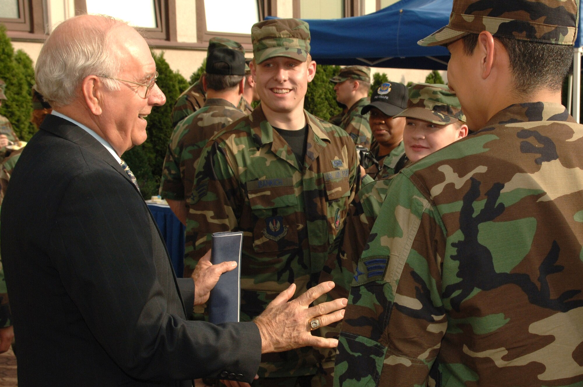 Former Chief Master Sergeant of the Air Force Sam E. Parish talks with Senior Airman Timothy Bankich (center) after a ceremony marking the opening of the Parish Enlisted Heritage Room that bears his name. (U.S. Air Force photo/Senior Airman Christopher Willis) 

