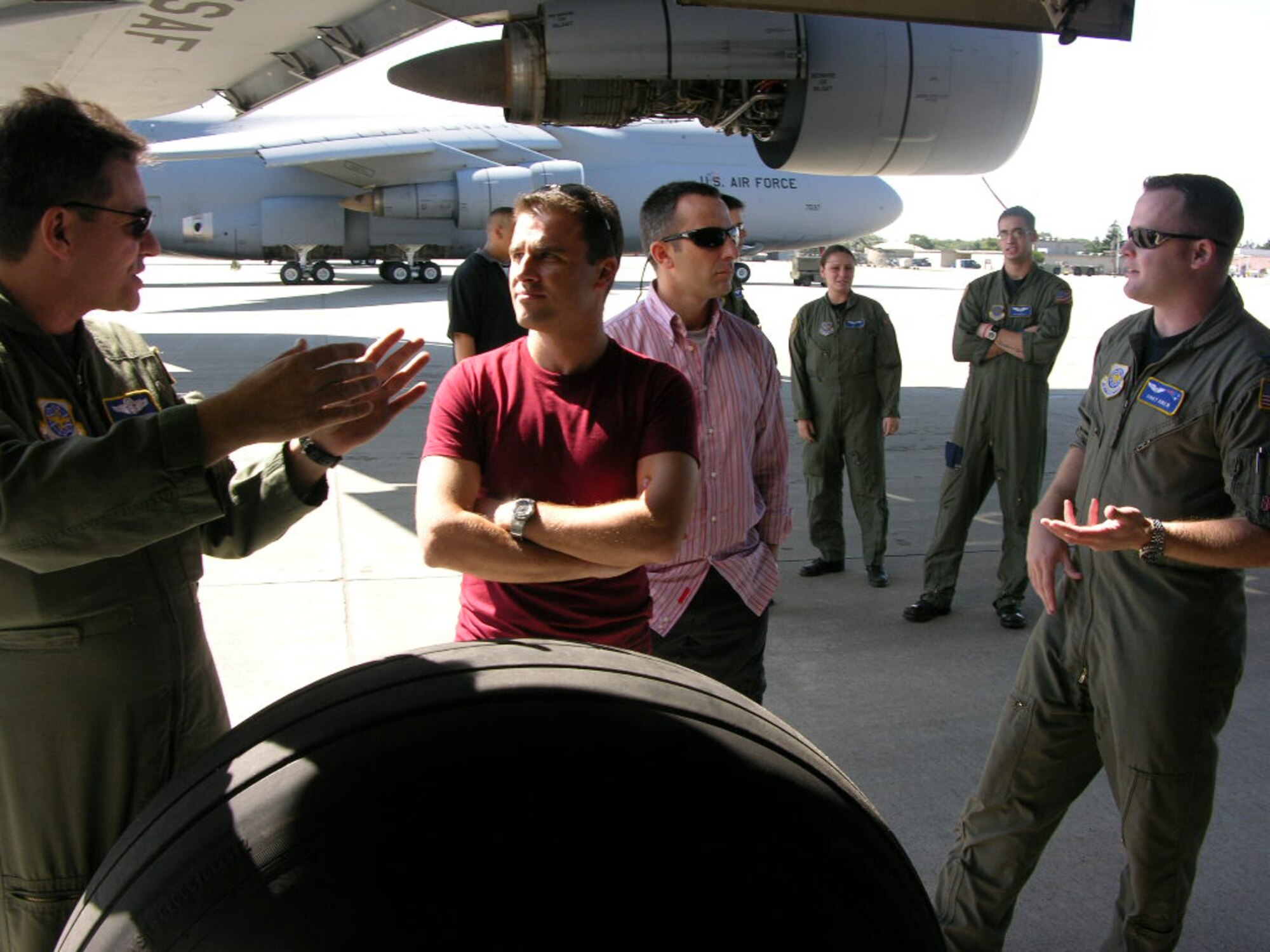 WESTOVER AIR RESERVE BASE, Mass. -- Air Force reservist Master Sgt. Art Dapaixao, left, explains the landing gear of a C-5 Galaxy to Maj. Jorge Barraso, a Spanish Air Force pilot, while Capt. Corey Aiken, a 337th Airlift Squadron pilot, explains the Galaxy to Maj. Manuel Alcaide, also a Spanish Air Force pilot. Captain Aiken and the other 337th crew members showed the entire huge airlifter to the Spanish pilots, who were visiting Westover Sept. 22 as part of airlifting United Nations delegates from Spain to New York City. (U.S. Air Force photo by Tech. Sgt. Andrew Biscoe)