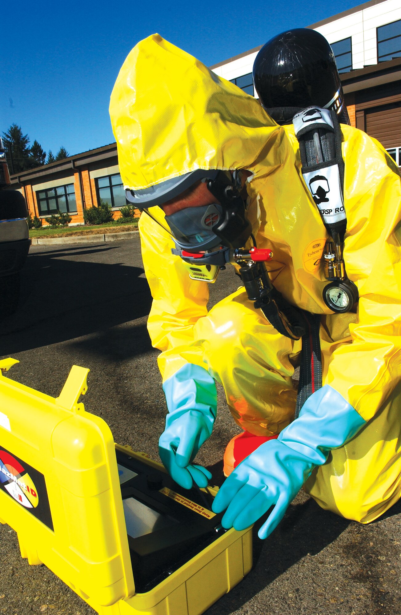 MCCHORD AIR FORCE BASE, Wash. — Staff Sgt. Bradley Ten Brink, 62nd MDOS, dressed in a level B chemical suit, demonstrates the proper procedure for identifying an unknown substance using the hazardous materials identification system. (U.S. Air Force photo/Abner Guzman)