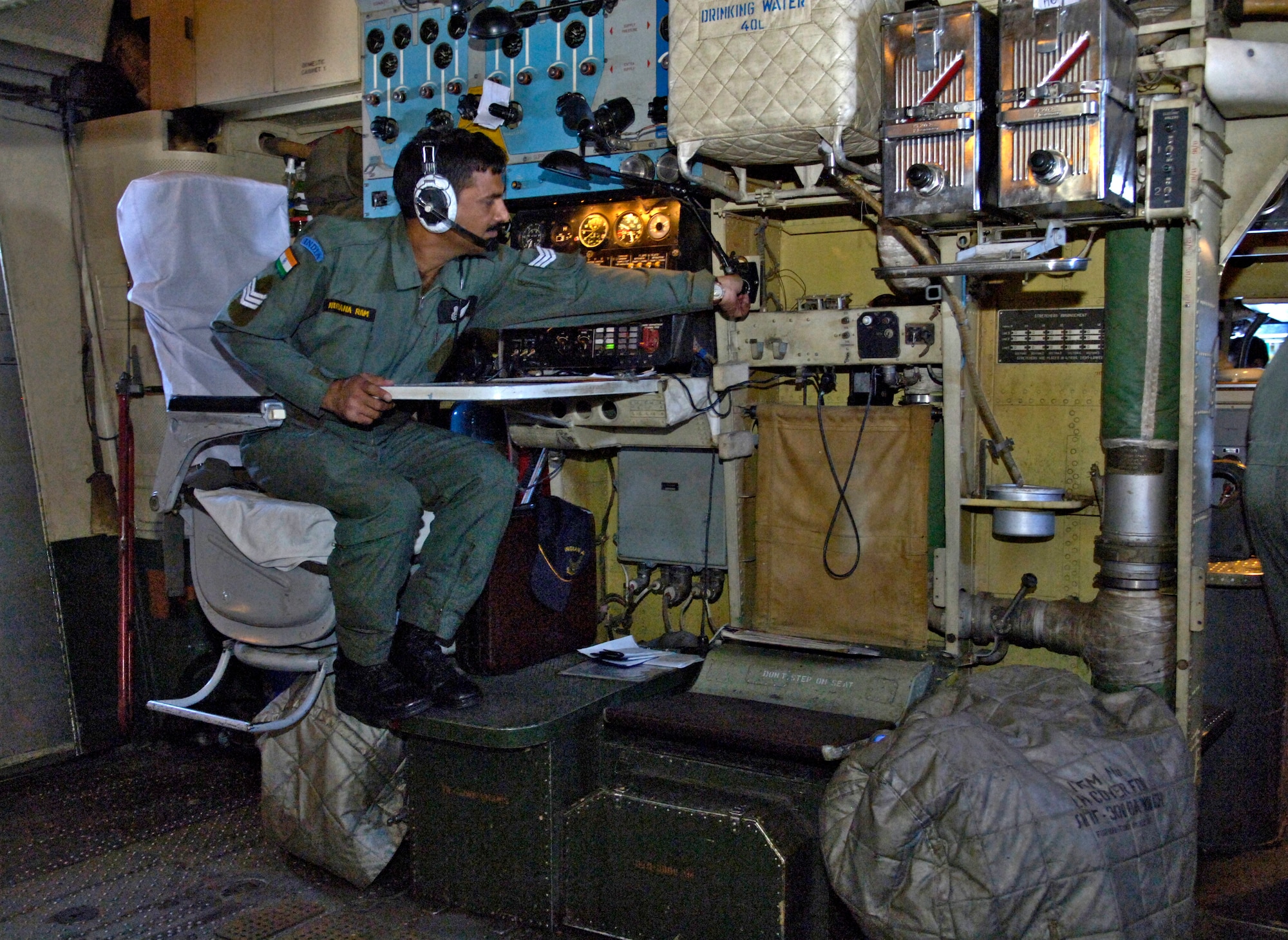Sgt. Nirana Ram adjusts controls at his aircrew station on an IL-76 medium cargo jet during a training mission over the big island of Hawaii Sept. 20, 2006. Sgt Ram is a flight gunner with the Indian Air Force. The Indian Air Force is flying members of the 15th Airlift Wing to show their American counter parts what their aircraft is capable of. (U.S. Air Force photo/ Tech. Sgt. Shane A. Cuomo)
