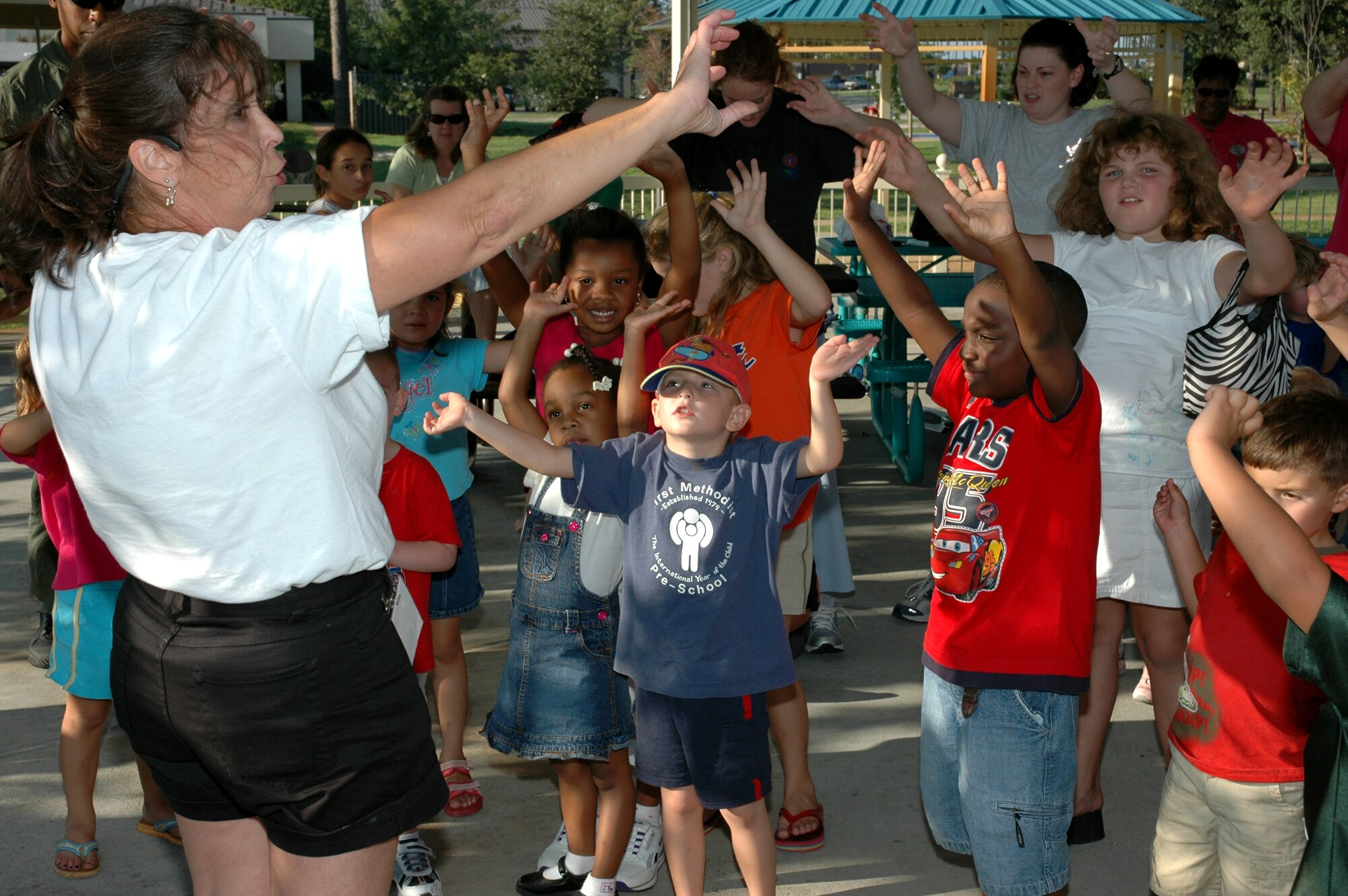 Maryann Harman, a music teacher from Pinellas County, leads a dance with Hurlburt Field children Sept. 15 at the pavilion in community park. She was here conducting training with the child development center. (U.S. Air Force Photograph by Master Sgt. Stuart Camp)