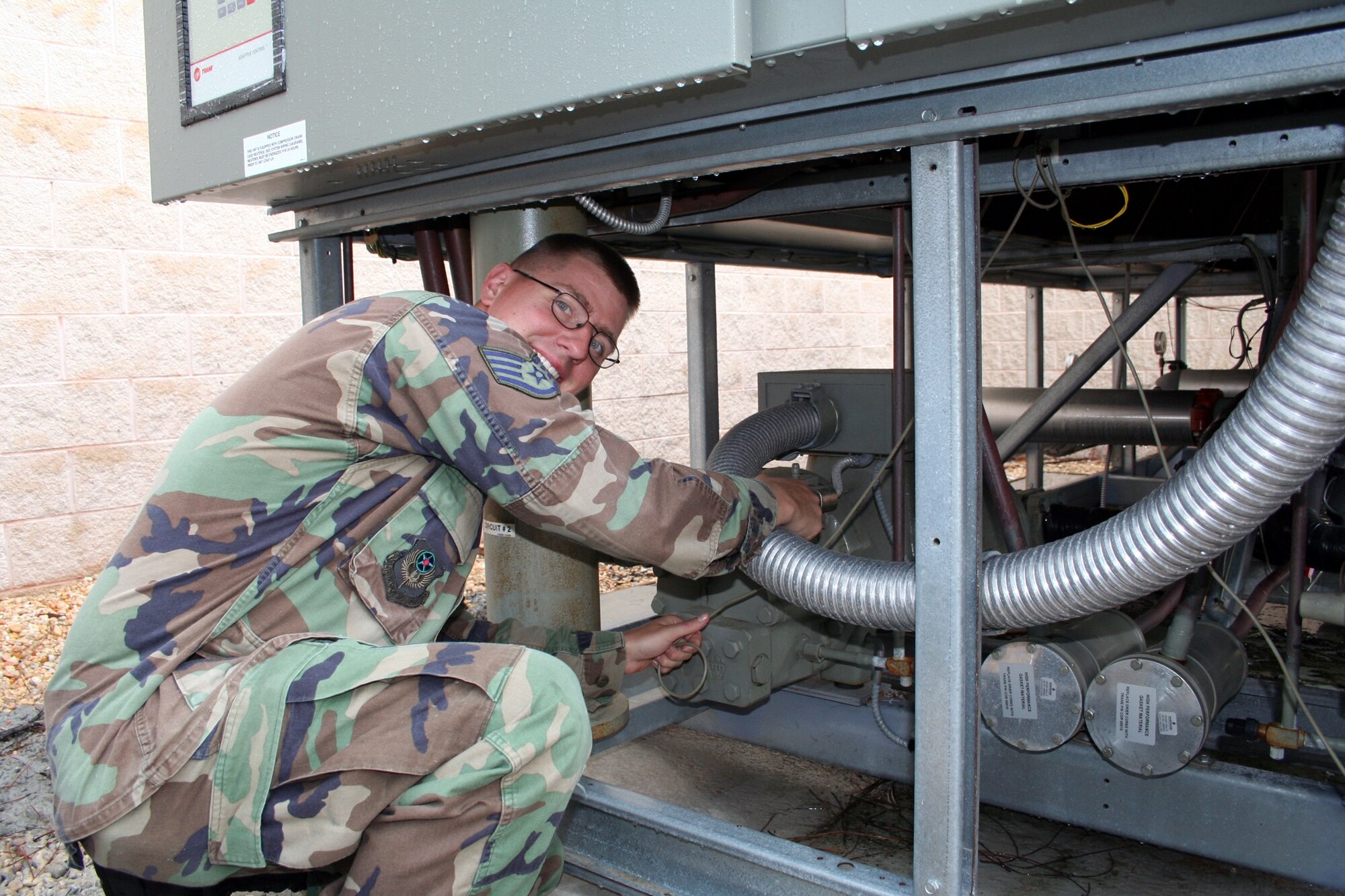 Staff Sgt. Brian Riordon, 16th CES HVAC/R, inspects an AC unit at the Deployment Control Center.