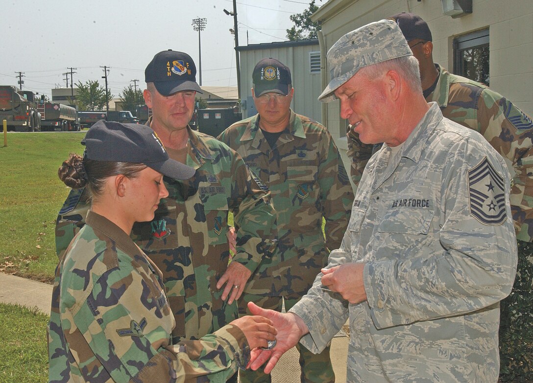 Chief Master Sgt. John Foran, 9th Air Force command chief, coins Airman Kareena Howard, 4th Logistic Readiness Squadron, during a visit to the base Sept. 11.  Seymour Johnson was Chief Foran?s first assignment in the Air Force, and this was one of his final stops before his upcoming retirement Oct. 4.                               