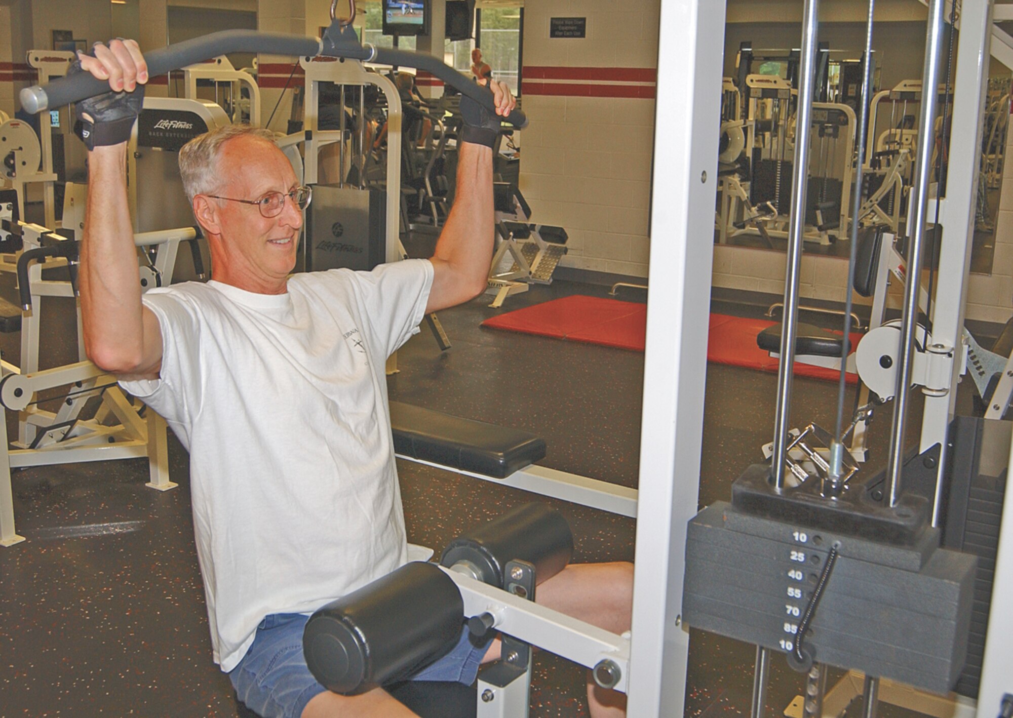Steve Lamb works out at the fitness center. Mr. Lamb is one of two dozen retirees known as the Q-tip crowd who take advantage of the benefits available to them at the fitness center.                               