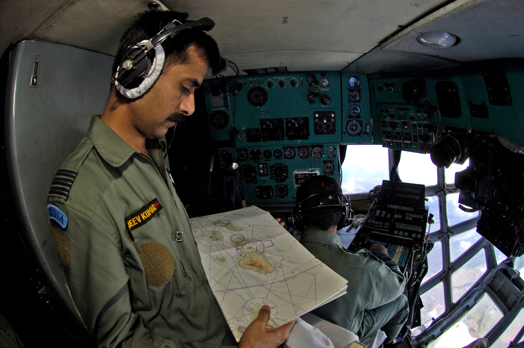 Wing Commander Sanjeev Gupta looks over a navigation map while flying over the big island of Hawaii in an IL-76 during a training mission Sept. 20. Wing Commander Gupta is a navigator in the Indian air force. (U.S. Air Force photo/ Tech. Sgt. Shane A. Cuomo) 