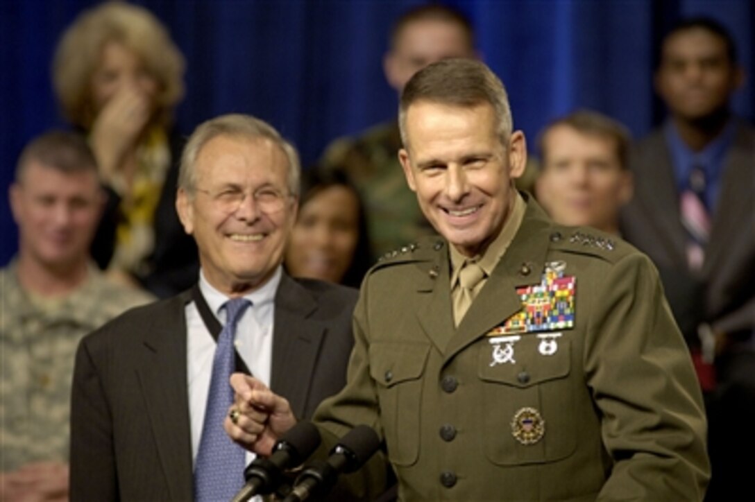 Chairman of the Joint Chiefs of Staff Gen. Peter Pace (right), U.S. Marine Corps, delivers his opening remarks at a town hall meeting in the Pentagon on Sept. 22, 2006.  Pace joined Secretary of Defense Donald H. Rumsfeld (left) in fielding questions from the audience of military and DoD civilian employees.  