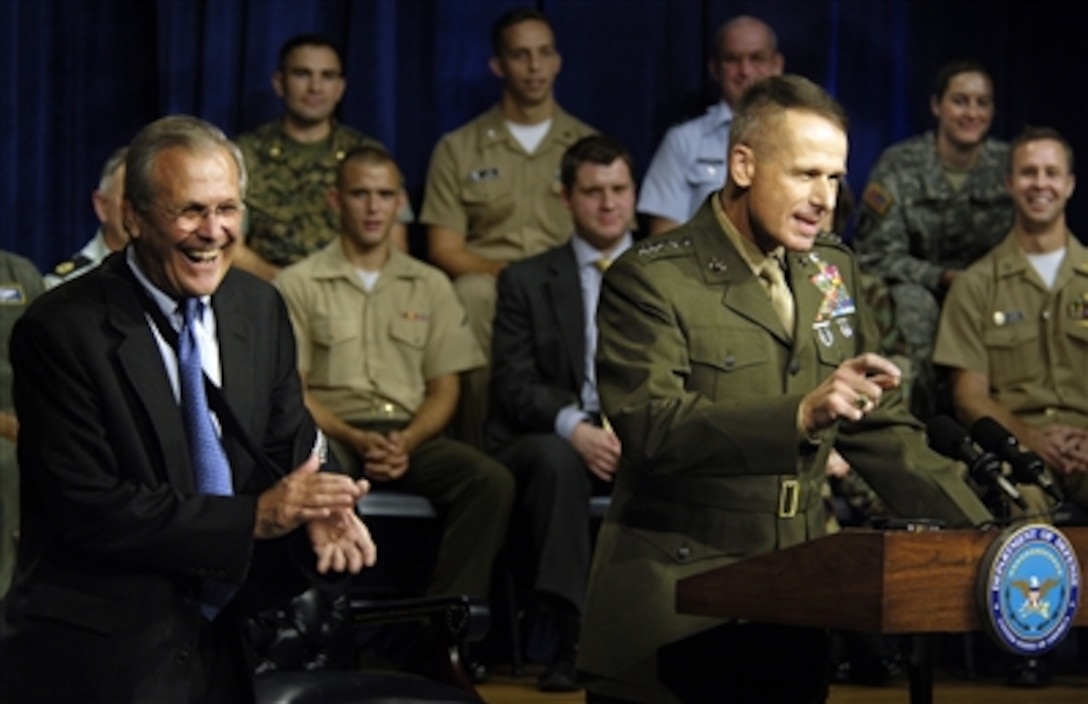 Chairman of the Joint Chiefs of Staff Marine Gen. Peter Pace draws a laugh from members of the audience and Secretary of Defense Donald H. Rumsfeld during a town hall at the Pentagon, Sept. 22, 2006. Questions asked of the two leaders  ranged from future base closings to war on terror. 