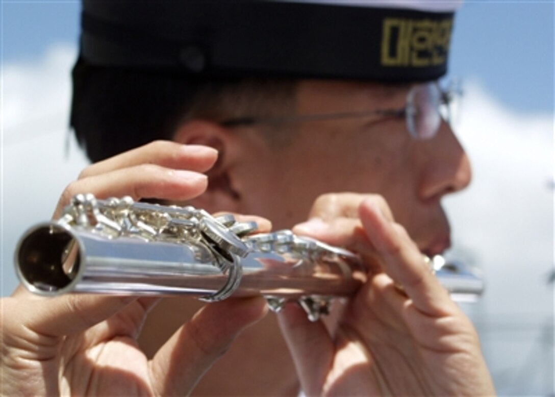 A Korean flutist aboard the Dae Jo Yeong plays following the arrival of two ships from the Republic of Korea's Cruise Training Force at Pearl Harbor, Hawaii, Sept. 21, 2006. 