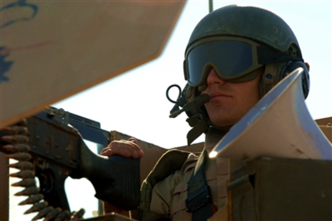 U.S. Air Force Staff Sgt. Luke Oaks provides security with an M 240B machine- gun during a convoy mission from Contingency Operating Base Speicher, Iraq, to Mosul, Iraq, on Sept. 16, 2006.  Oaks is assigned to the 557th Expeditionary Red Horse Squadron's Convoy Team.  