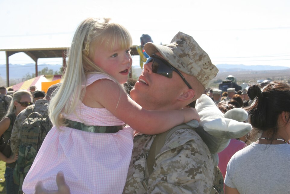 Three-year-old Grace Wolfenbarger welcomes home her father, Capt. Craig A. Wolfenbarger, commanding officer of Company B, 1st Battalion, 7th Marine Regiment, at Victory Field Sept. 23.