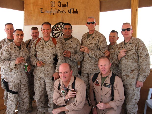 Marines and sailors with various units at Al Asad, Iraq, pose for a photo in the "Don's Cabana" during a get together of the Lamplighter's Club Sept. 25.