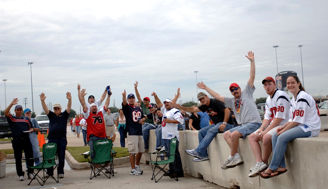 Houston Texans fans yell out their support for military servicemembers during their tailgate party in the parking lot of Reliant Stadium in Houston Sept. 24. The game between the Houston Texans and Washington Redskins was designated as the Houston Texan's Salute to the Military day by team officials. (U. S. Air Force photos/Tech Sgt. Cecilio M. Ricardo)   