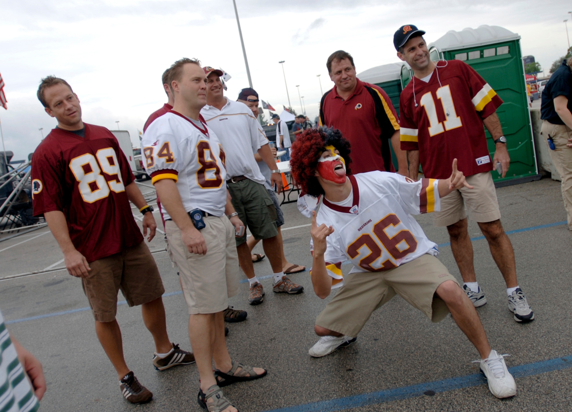 Washington Redskins fan Airman 1st Class Nicholas Sandoval and his friends yell and pose for a picture during their tailgate party in the parking lot of Reliant Stadium in Houston Sept. 24 prior to the Houston Texans and Redskins National Football League game. Airman Sandoval is from the 509th Aircraft Maintenance Squadron from Whiteman Air Force Base, Mo.  (U. S. Air Force photos/Tech. Sgt. Cecilio M. Ricardo) 