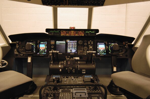 A full-scale model of a C-5 Galaxy cockpit, called a combined avionics systems trainer, or CAST, will be used by instructors at Dover Air Force Base, Del., to help train maintainers who will fix avionics systems on the C-5.  The trainer comprises five separate sections including a forward cockpit station, navigator station, an aircraft silhouette, an avionics station and an instructor station.  (U.S. Air Force photo/Senior Airman James Bolinger)