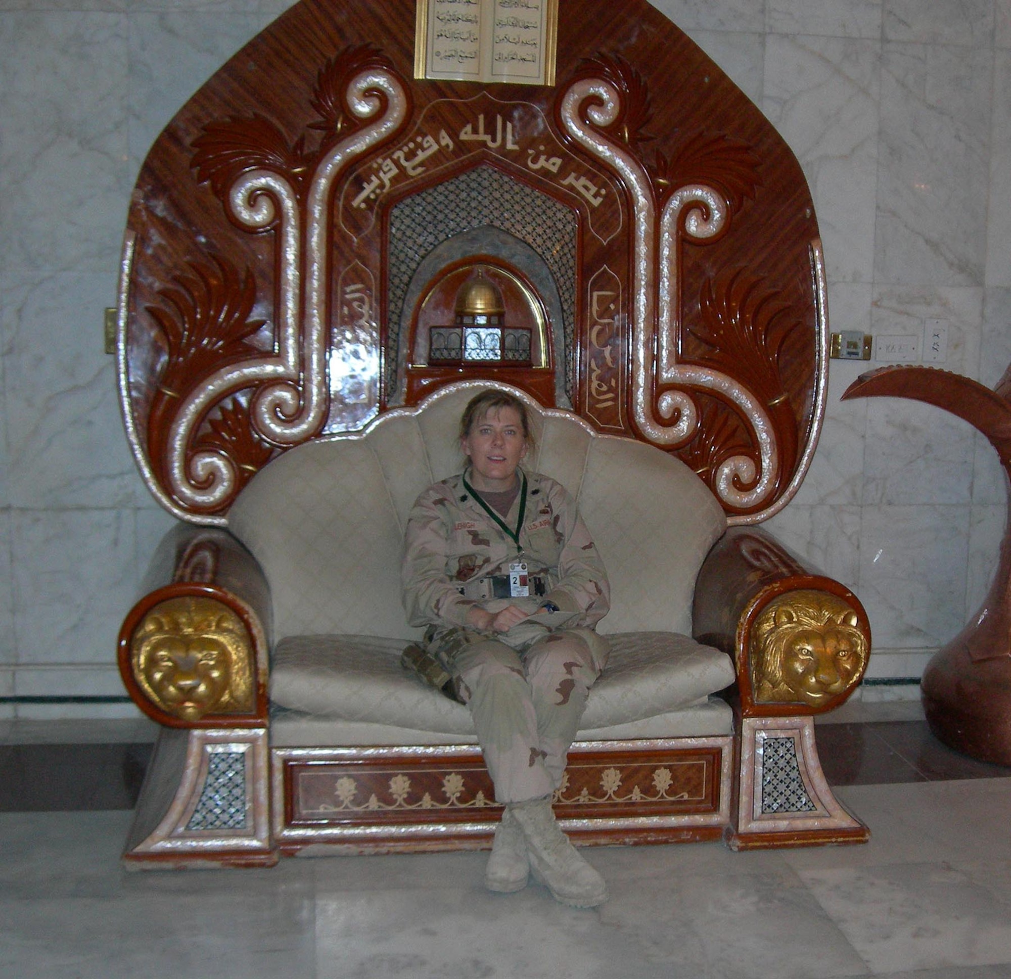 Lt. Col. Deann Lehigh sits in the throne of one of Saddam Hussein's former palaces while on duty in Iraq.