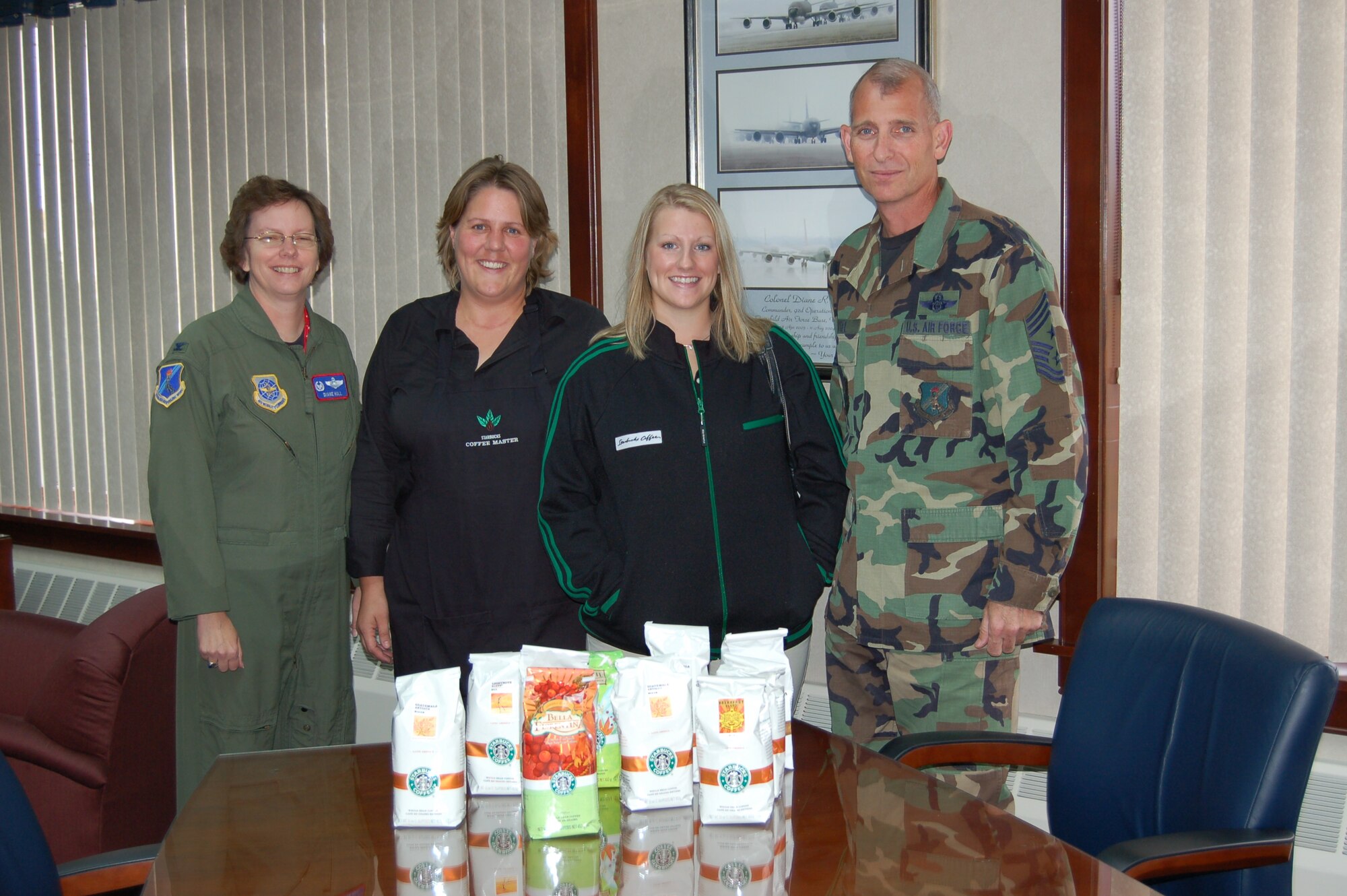 (From left to right) Col. Diane Hull, 319th Air Refueling Wing commander; Lisa Bakke and Crystal Hurst, Starbucks store managers; and Chief Master Sgt. Harry Viel. 
The managers of the local Starbucks coffee shops presented 179 pounds of coffee to be distributed to deployed troops. 
“The coffee was donated from the community, our store just facilitated the donations,” said Ms. Bakke. “Many people included thank you cards to show their appreciation to the troops.” (Photo by Airman 1st Class Ashley Coomes)