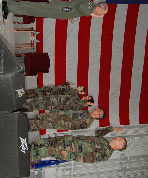 Gen. Duncan McNabb, Air Mobility Command commander, re-enlists four Airmen during the all call during his visit Sept. 13 and 14. (Photo by Airman 1st Class Ashley Coomes)