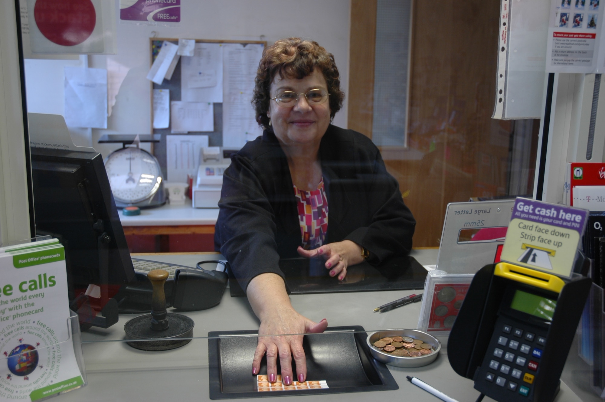 Mrs Hester Hope offers a bit of British cheer to customers at the family-owned British Post office on RAF Lakenheath. (U.S. Air Force photo by Teresa McNamara)

