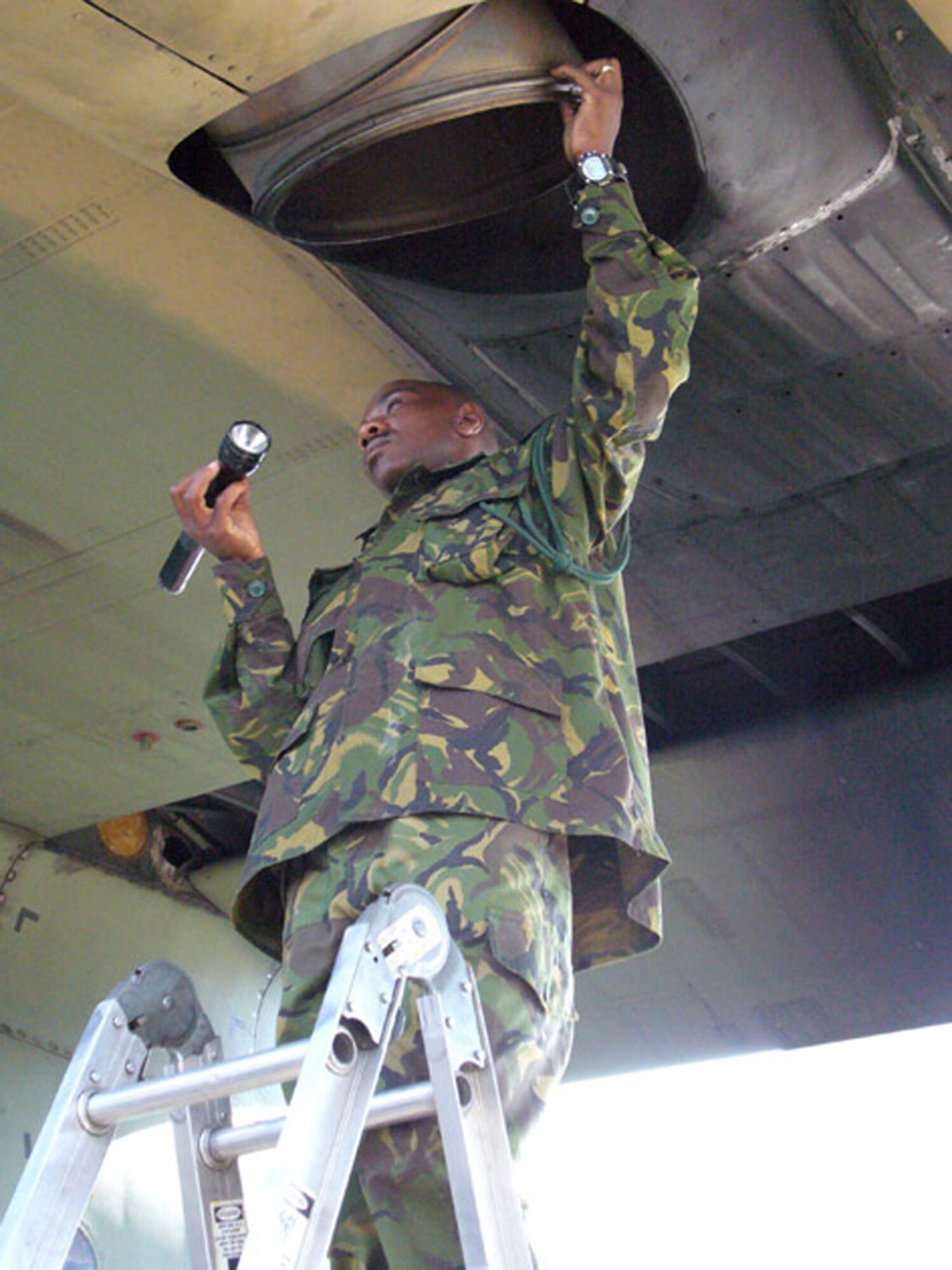 Botswana Defence Force Lance Cpl. Kobamelo Dabelo, C-130 technician, conducts a preflight inspection of the aircraft Sept. 24 at the Kigali International Airport in Rwanda. (U.S. Air Force photo/Capt. Erin Dorrance)
