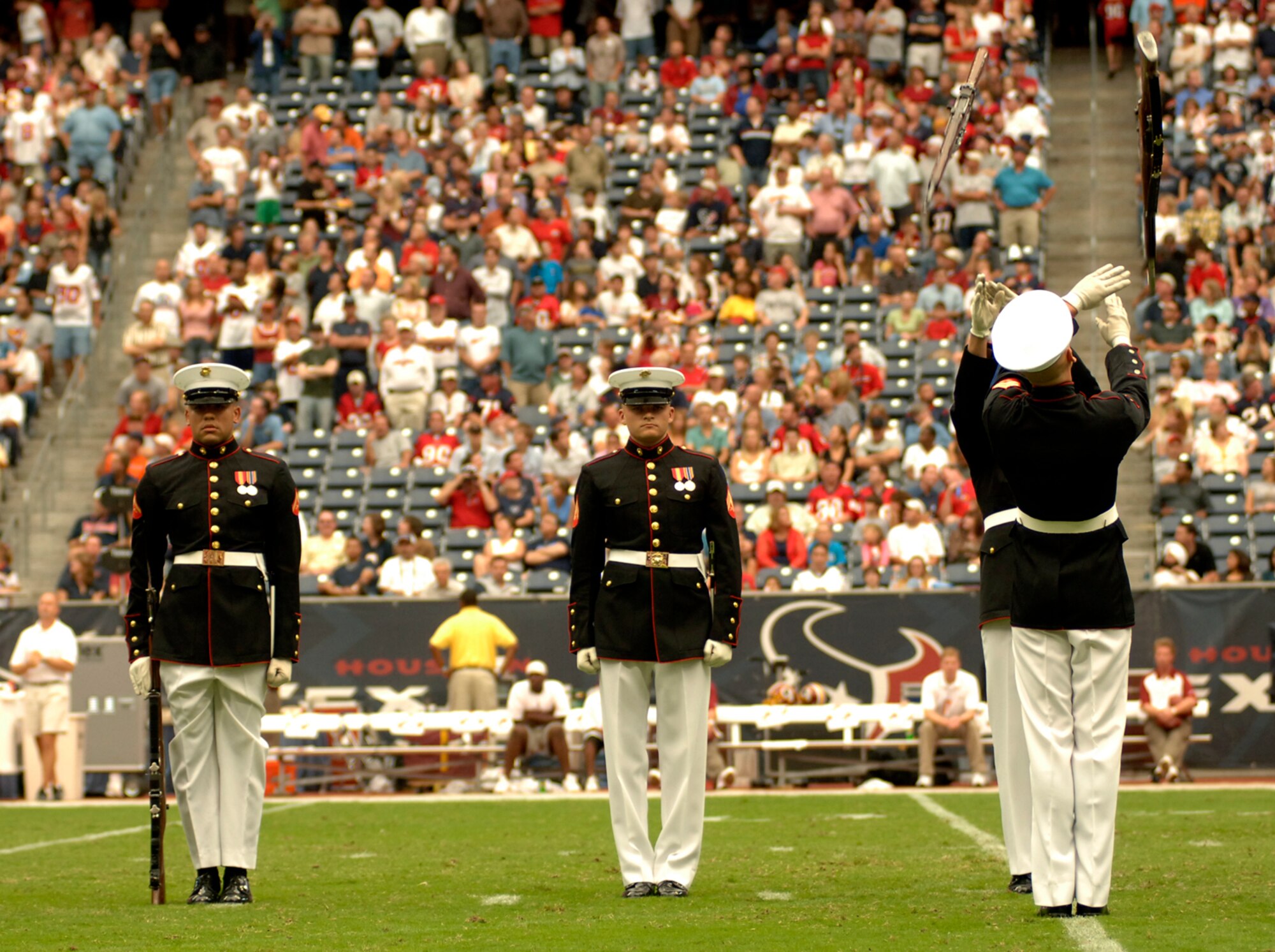 The Marine Corps Silent Drill Team from Washington, D.C., performs in front of more than 70,000 fans at Reliant Stadium in Houston at halftime of the Houston Texans and Washington Redskins National Football League game Sept. 24. The Texans honored military servicemembers in their Salute to the Military day. (U.S. Air Force photo/Tech. Sgt. Cecilio M. Ricardo Jr.)