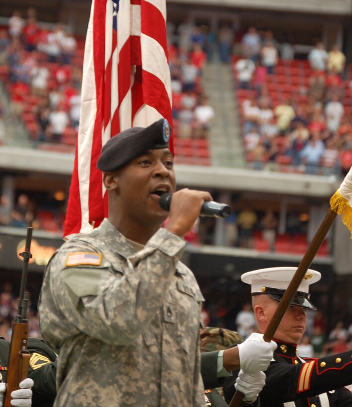 Army Staff Sgt. Santantoniano Smith from the Houston Recruiting Battalion sings the national anthem in front of a joint color guard from Houston at Reliant Stadium prior to the Houston Texans and Washington Redskins National Football League game Sept. 24. The Texans honored servicemembers in their Salute to the Military day. Photo by Tech. Sgt. Ben Gonzales, USAF