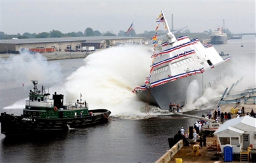 The nation’s first Littoral Combat Ship, Freedom, makes a spectacular side launch during her christening at the Marine shipyard in Marinette, Wis., Sept. 23, 2006. The agile 377-foot Freedom will help the U.S. Navy defeat growing littoral, or close-to-shore, threats and provide access and dominance in coastal water battle space.