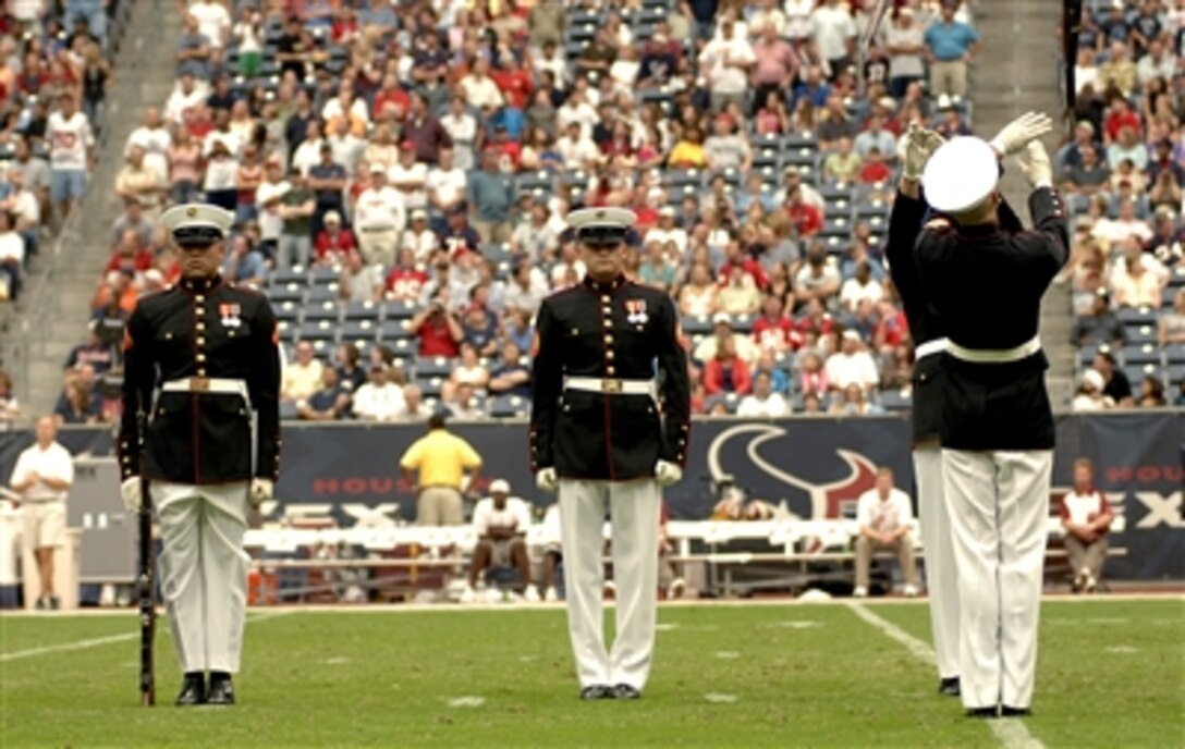 The Marine Corps Silent Drill Team from Washington, D.C., performs at Reliant Stadium in Houston at halftime of the Houston Texans and Washington Redskins National Football League game Sept. 24, 2006. Military members were spotlighted as part of the Texans' “Salute to the Military” day.