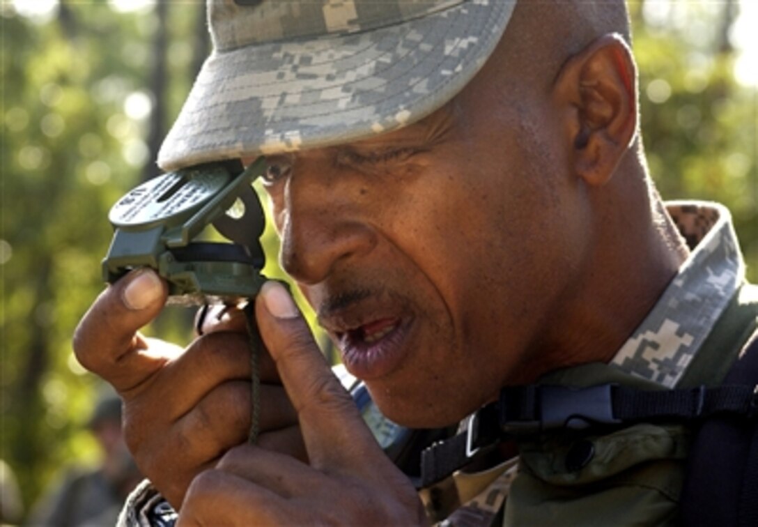 A U.S. Army Drill Sgt. takes an azimuth reading with a compass during a situational training exercise as part of Army basic training at Fort Jackson, S.C., Sept. 19, 2006. 
