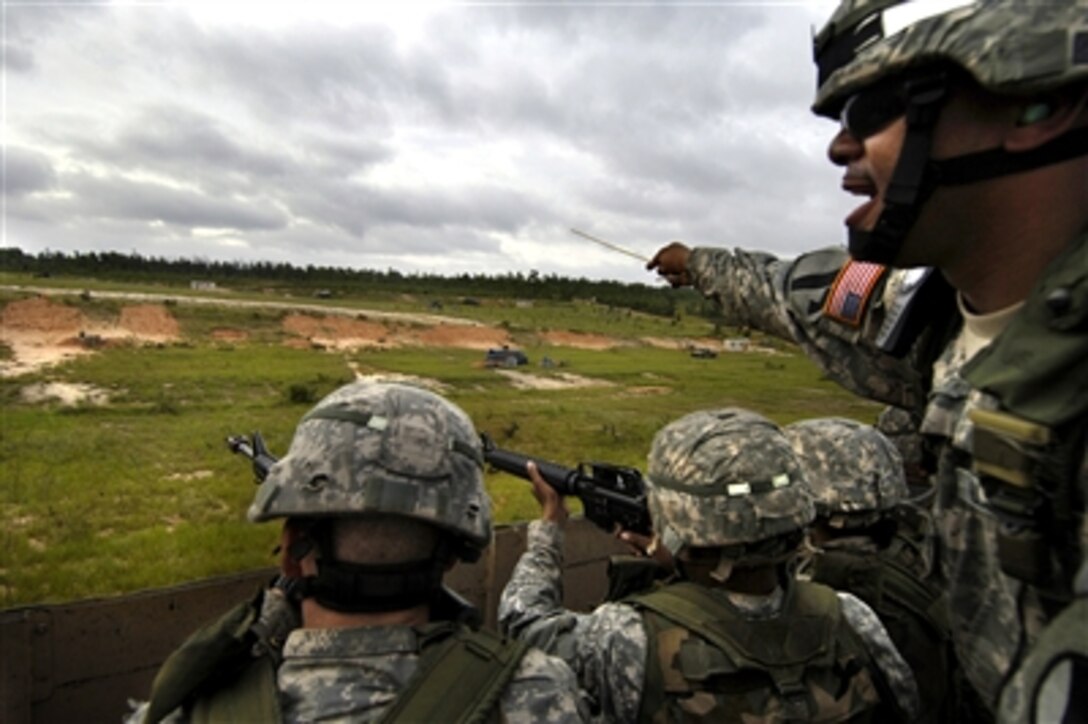 U.S. Army privates listen as their Drill Sgt. instructs them to keep their weapons pointed down range during a convoy live-fire exercise as part of Army basic training at Fort Jackson, S.C., Sept. 19, 2006.  