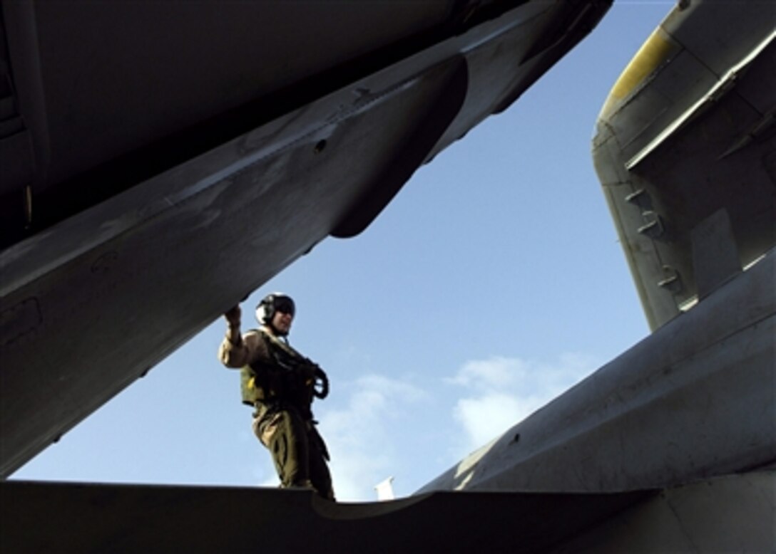 U.S. Navy Lt. j.g. Stephen Sweeney checks an EA-6B Prowler aboard the nuclear-powered aircraft carrier USS Enterprise in the Arabian Sea, Sept. 22, 2006.