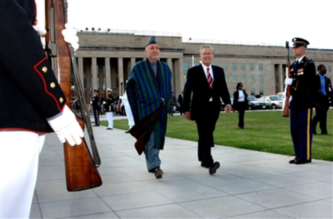 Secretary of Defense Donald H. Rumsfeld and President of Afghanistan Hamid Karzai attend an armed forces full honor cordon at the Pentagon Sept. 25, 2006.  Karzai is in Washington, D.C. to meet with senior defense officials. 