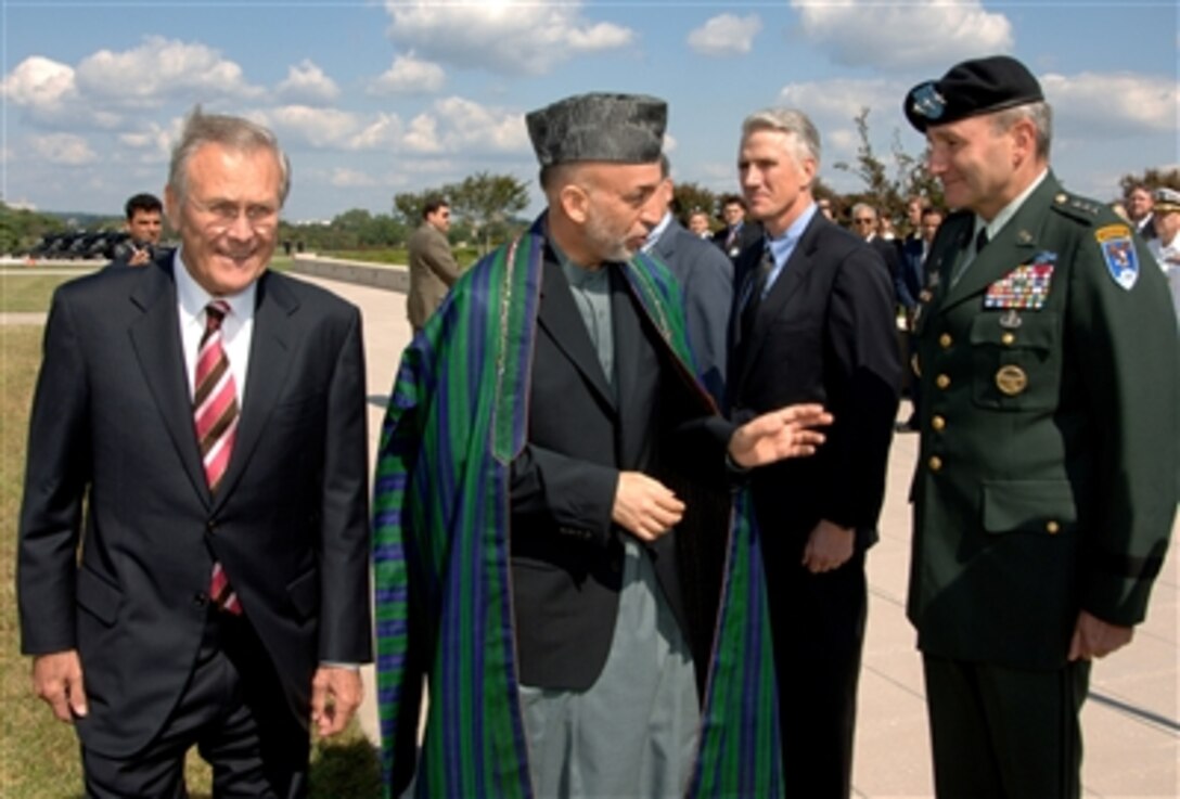 Secretary of Defense Donald H. Rumsfeld and President of Afghanistan Hamid Karzai meet with defense department officials during a full honor cordon at the Pentagon Sept. 25, 2006. 