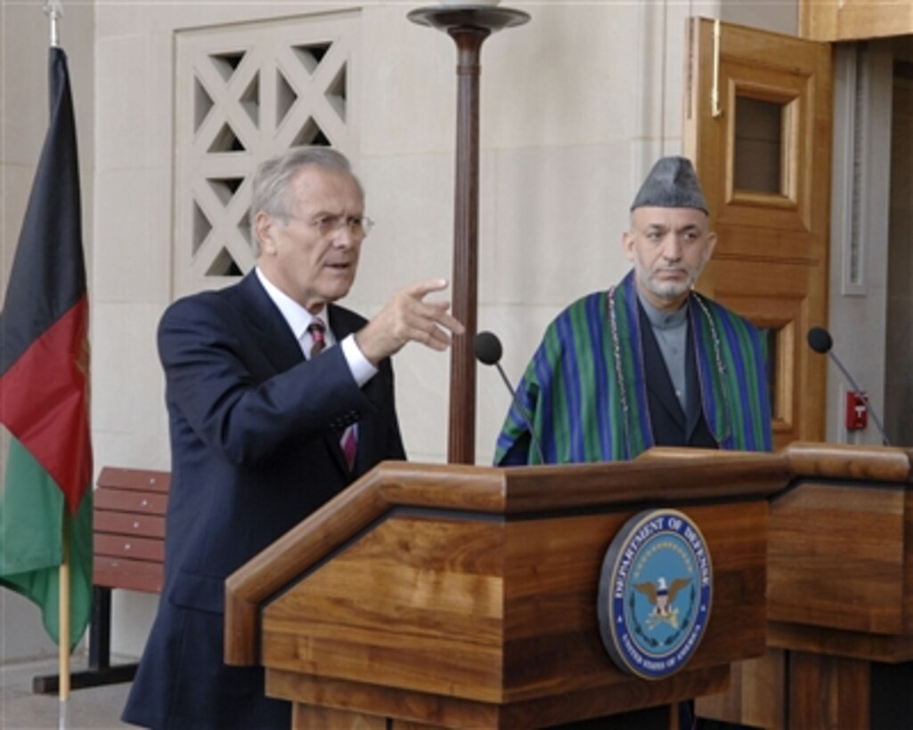 Secretary of Defense Donald H. Rumsfeld (left) calls on a reporter during a joint press briefing with Afghan President Hamid Karzai (right) at the Pentagon on Sept. 25, 2006.  Rumsfeld and Karzai met with the press following their meetings.  