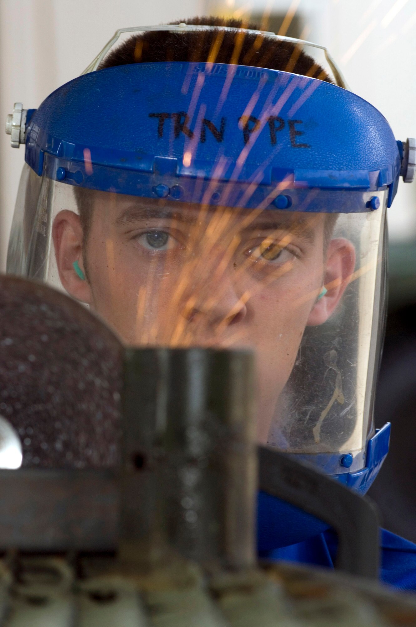 Senior Airman Brian Roub removes paint from a section of an aircraft maintenance stand Sept. 20 while preparing to weld at Sembach Air Base, Germany. Airman Roub is a vehicle body mechanic with Sembach's 435th Materiel Maintenance Squadron. (U.S. Air Force photo/Master Sgt. John E. Lasky) 