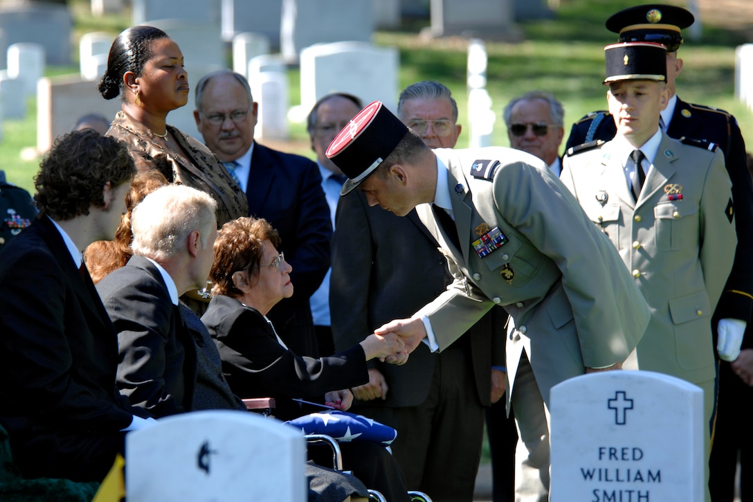 French military officials greet Rachel Kleisinger, the only known living family member of formerly missing U.S. Army Pvt. Francis Lupo, who died in 1918 in France. Lupo’s remains were found in France in 2003 and recently identified by U.S. military experts. He was buried in Arlington National Cemetery on Sept. 26. Photo by William D. Moss