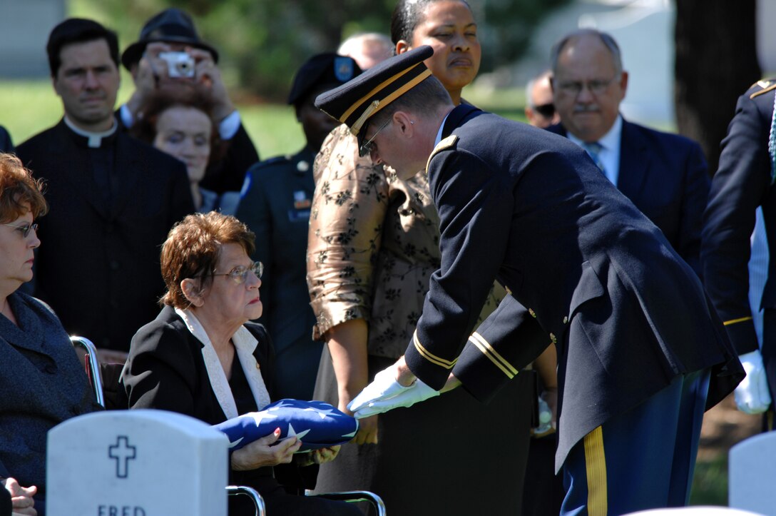 A member of the 3rd U.S. Infantry presents Rachael Kleisinger a folded ...