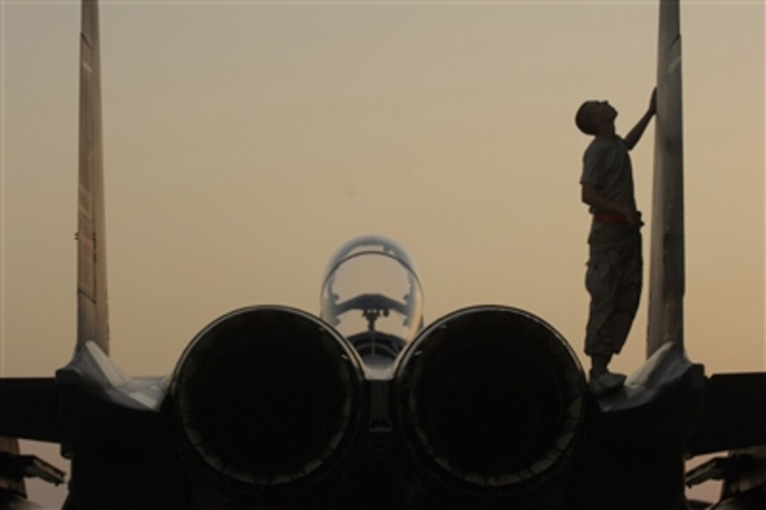 U.S. Air Force Airman 1st Class Kevin Romer performs a post-flight inspection on an F-15 Strike Eagle aircraft in Southwest Asia on Sept. 21, 2006.  Romer is attached to the 494th Aircraft Maintenance Unit and the aircraft is from the 494th Fighter Squadron, Lakenheath Royal Air Force Station.  