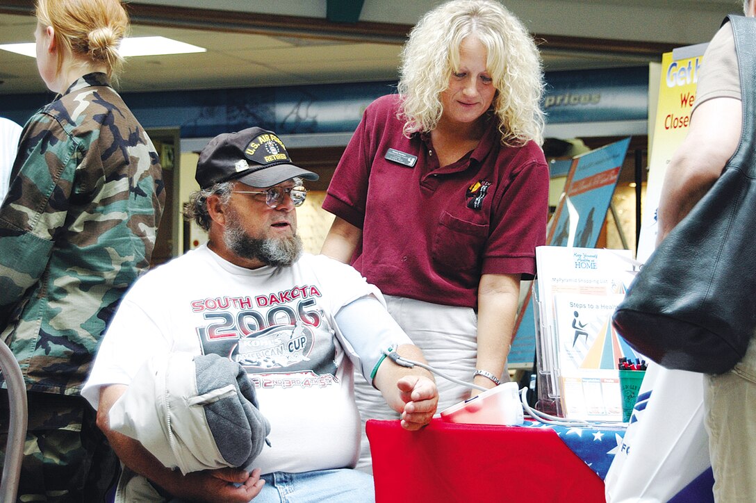 John Sabrowski, retired Air Force staff sergeant, gets his blood pressure checked by Minda Smither, Ellsworth Health and Wellness Center element chief, at a booth during Retiree Appreciation Day Sept. 15. Appreciation day is designed to provide a one-stop shop for retirees to get questions answered and benefit from the services of the numerous base agencies in one location. (Photo by Airman Riley)