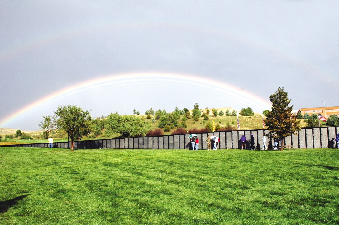 Visitors, veterans and family members observe the traveling Vietnam Wall in Pierre Saturday, Sept. 16, after the dedication ceremony. "The Wall" is a replica of the Vietnam Veterans National Memorial located in Washington, D.C. (Photo by 1st Lt. Carrie L. Kessler)