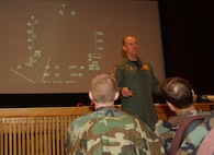 MINOT AIR FORCE BASE, N.D.  -- Col. Mike Roberts, 178th Fighter Wing vice commander, from Springfield Air National Guard Base, Ohio, talks to Airmen at the base theater about his experiences as a former POW. Colonel Roberts used his cockpit’s heads up display video from the evening of January 19, 1991 to describe how his F-16 was shot down during a bombing raid over Baghdad, Iraq during Operation Desert Storm. The colonel was the guest of honor during the base’s POW/MIA Recognition Day Sept. 22. (U.S. Air Force photo by Staff Sgt. Joe Laws)