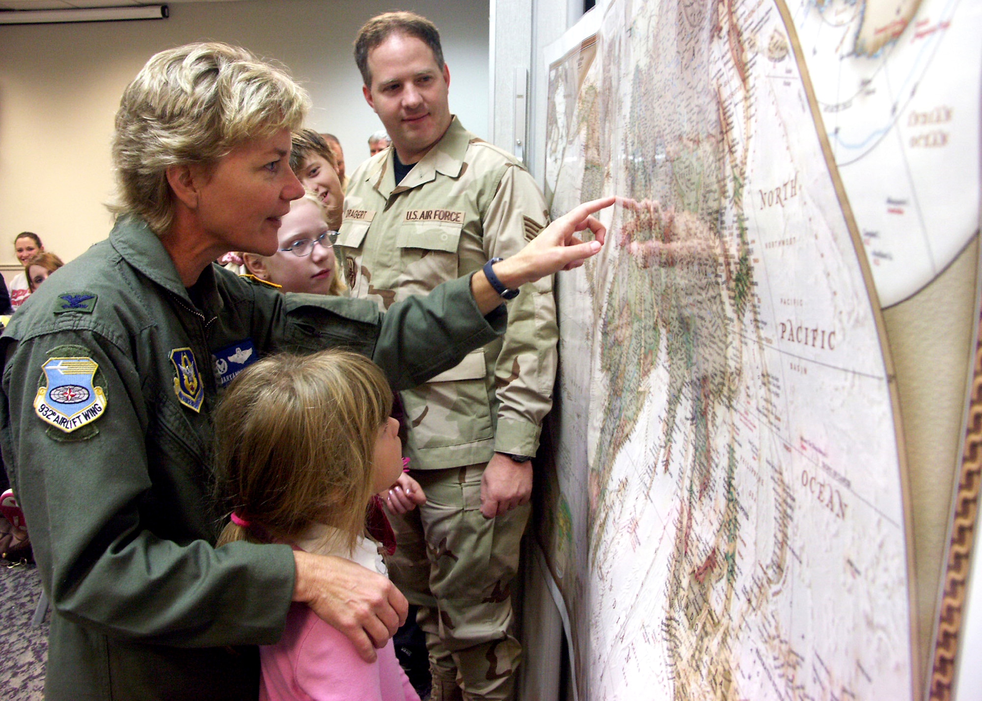 Colonel Maryanne Miller, the commander of the 932nd Airlift Wing, explains to children of her reservists how they will be transported overseas for a deployment.  Looking on with interest before heading out is Staff Sergeant Dale Dragert.  The Air Force Reserve Command unit is located at Scott Air Force Base, Ill.