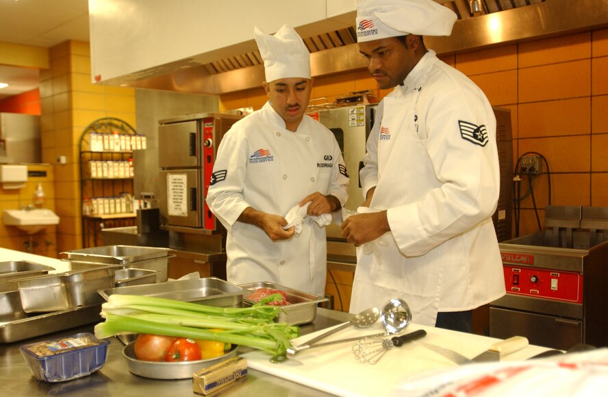 MINOT AIR FORCE BASE, N.D.  -- Staff Sgt. Ricky DuPree and Senior Airman Alejandro Rodriguez, both from the 742nd Missile Squadron, strategize about how to prepare their meal during the 91st Space Wing's 2nd annual Iron Chef Competition Sept. 23, 2006. (U.S. Air Force photo by Airman Sharida Bishop)