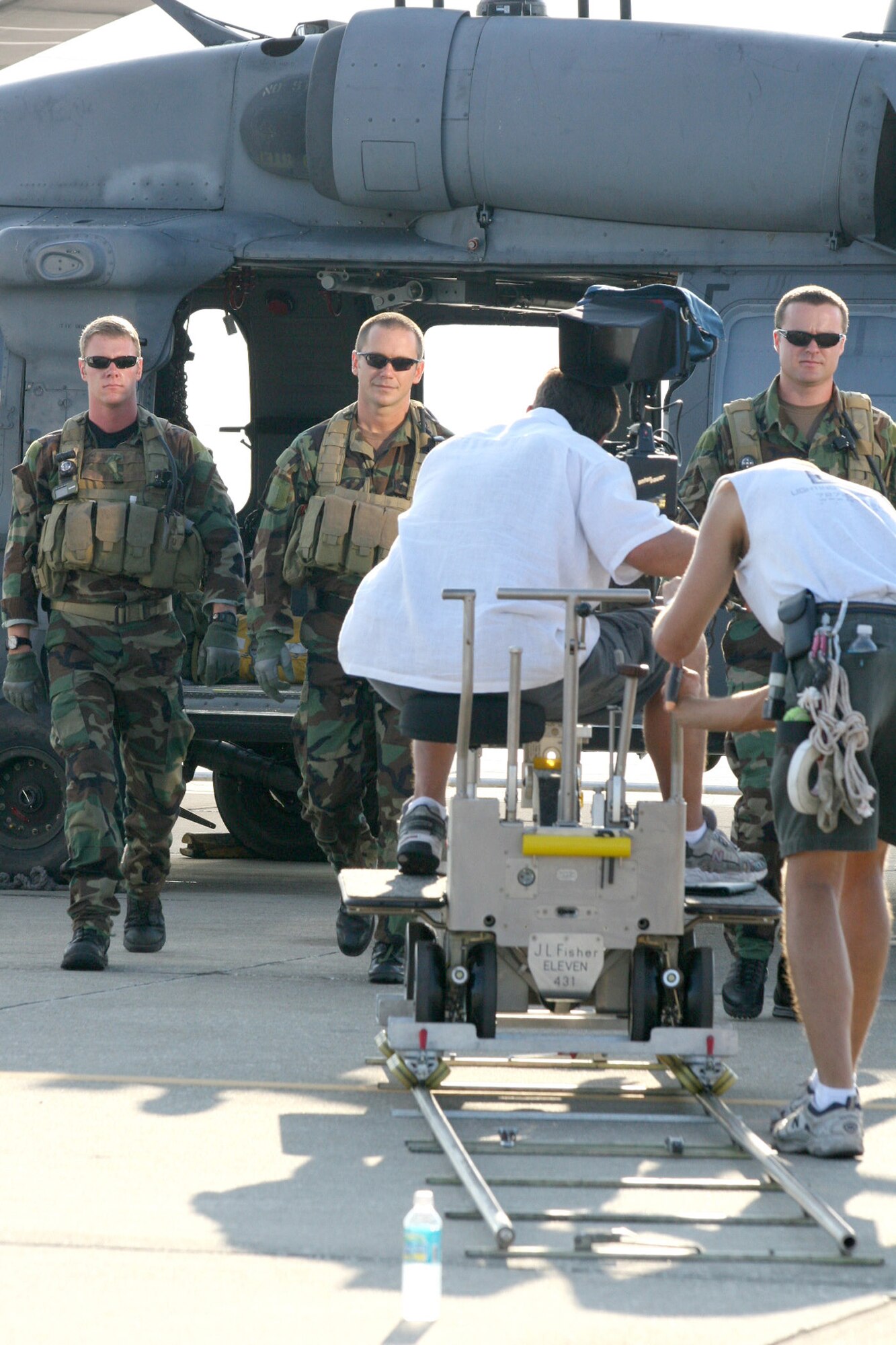 Staff Sgt. Kacee Holmes (left), pararescueman, Capt. John Fish, combat rescue officer, and Staff Sgt. Rusty Drake, pararescueman, all with the 308th Rescure Squadron, Patrick AFB, Fla., treck toward cameramen during a recruiting PSA shoot , Sept. 21, to promote Air Force Reserve membership and membership in the Pararescueman (PJ) Program. The 920th Rescue wing is the only Air Force Reserve wing equipped with PJs. (U.S. Air Force photo by Tech. Sgt. Robert Grande).